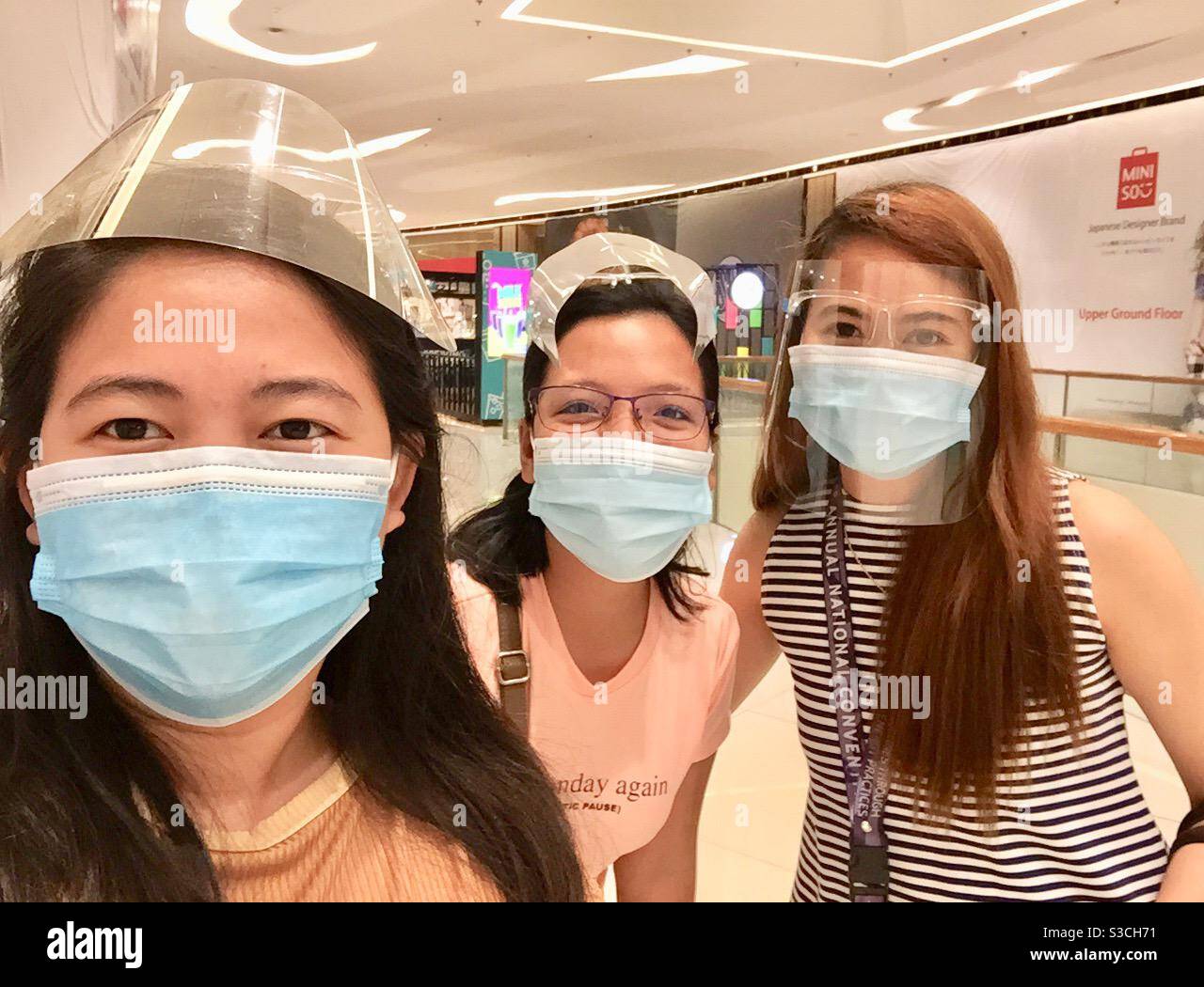 Three girls wearing mask at the mall Stock Photo Alamy