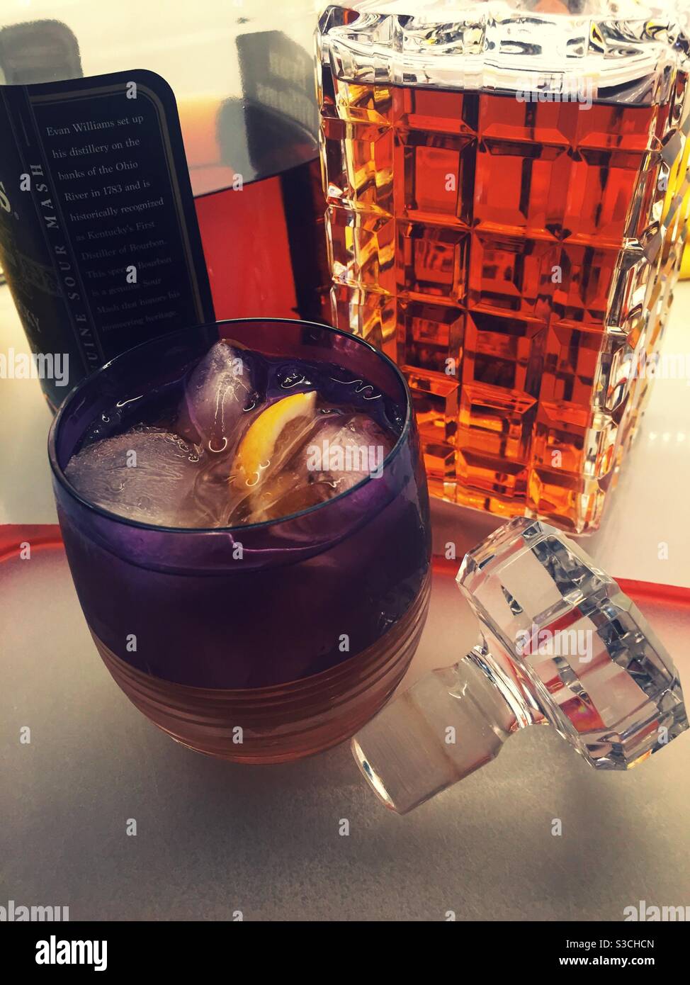 Culligan Crystal Tumbler  filled with a Manhattan on the rocks in front of a crystal decanter, USA - Smartphone Captured Stock Image