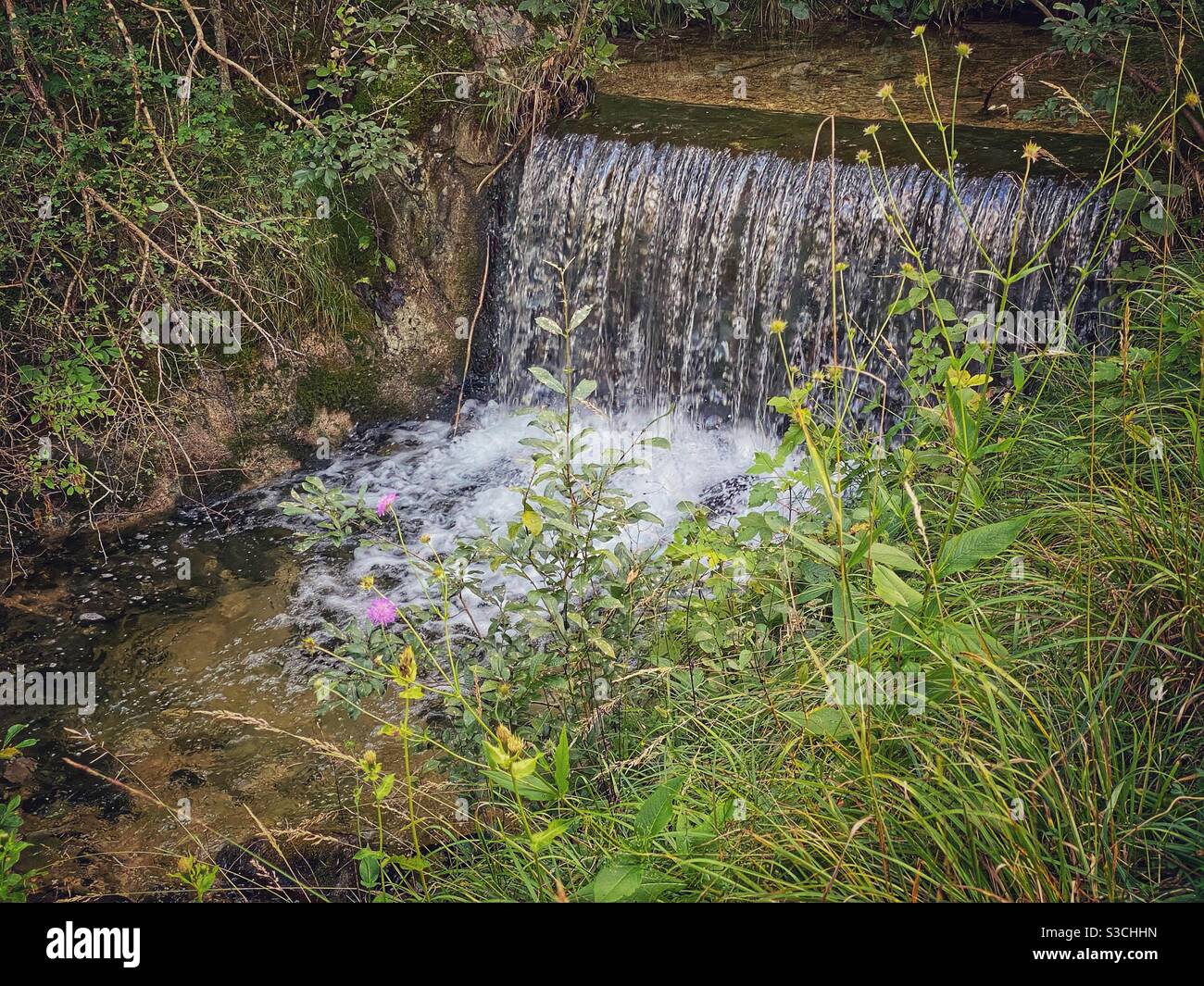 Alpine waterfall on a hiking trail from Kranzberg mountain back to the center of Mittenwald, Germany. - Smartphone Captured Stock Image