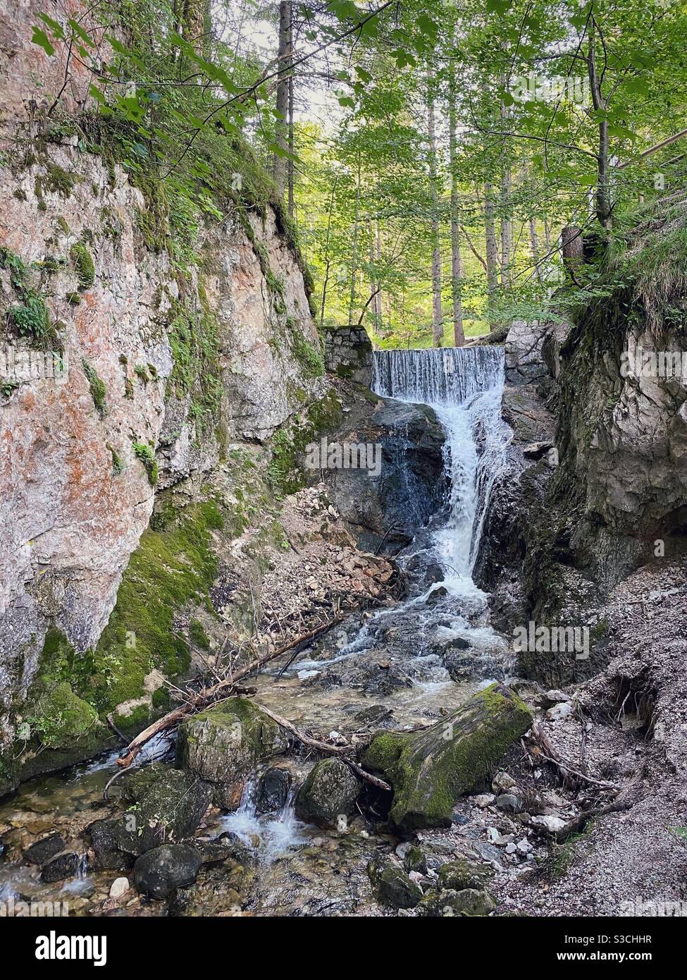 Alpine waterfall on a hiking trail from Kranzberg mountain to Mittenwald in Bavarian Alps, Germany. - Smartphone Captured Stock Image