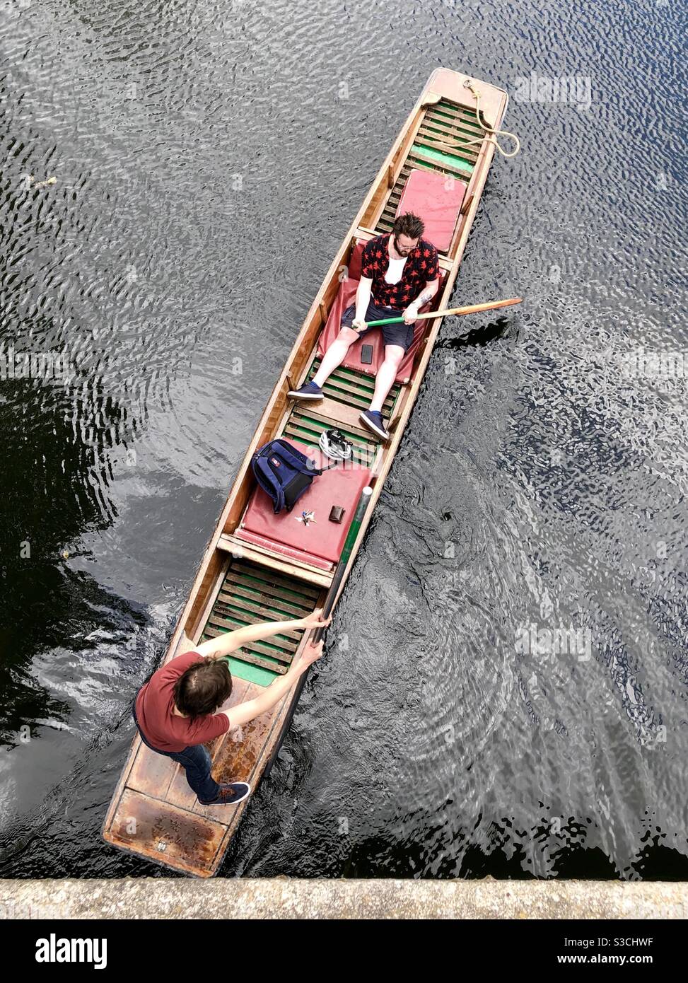 Looking down on two men in a punt on the river Cam Stock Photo