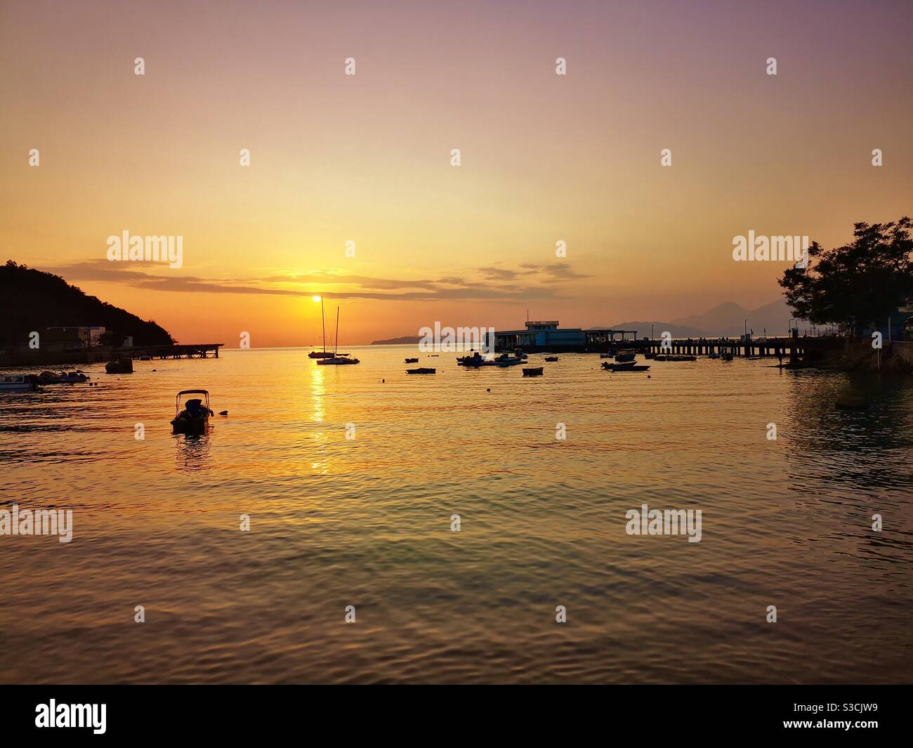A beautiful sunset seen from Lamma island in Hong Kong. - Smartphone Captured Stock Image