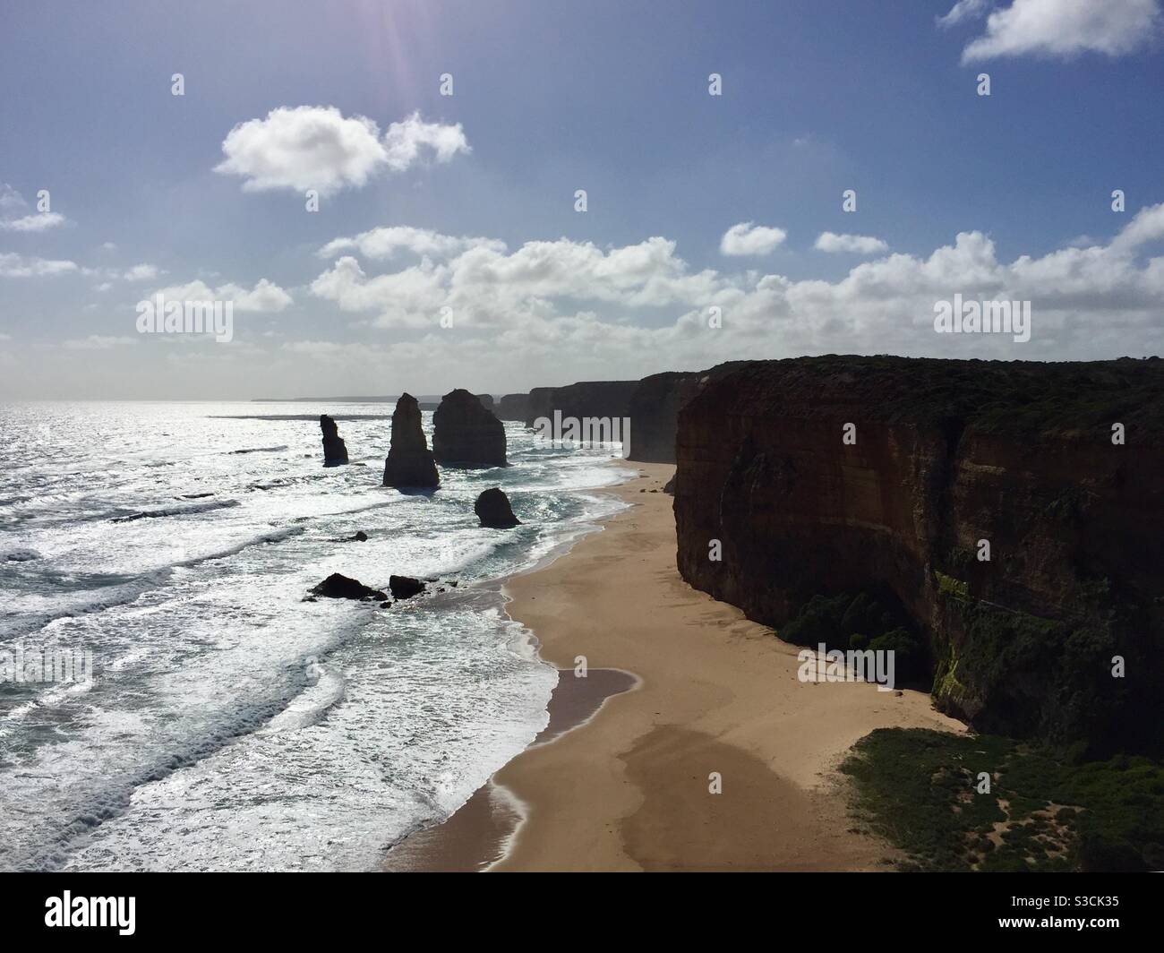 Sun bouncing off the surf at the 12 Apostles on the Great Ocean Road Victoria Australia Stock Photo