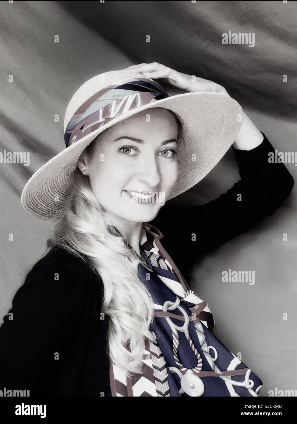 A smiling young woman in a hat and scarf. - Smartphone Captured Stock Image