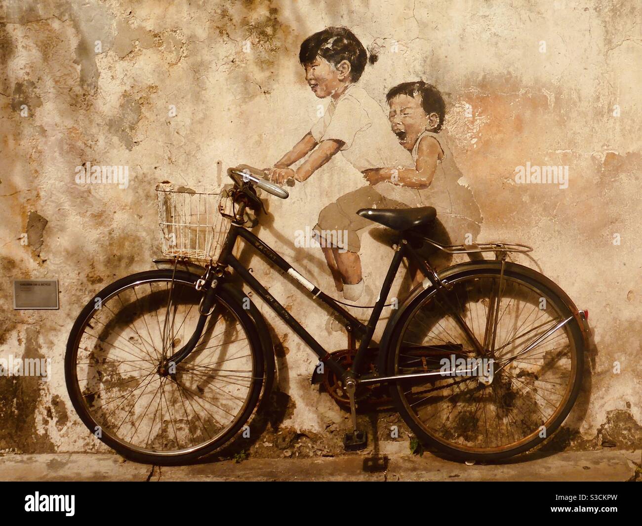 Kids on a bicycle street art by Ernest Zacharevic in Georgetown Penang Malaysia Stock Photo