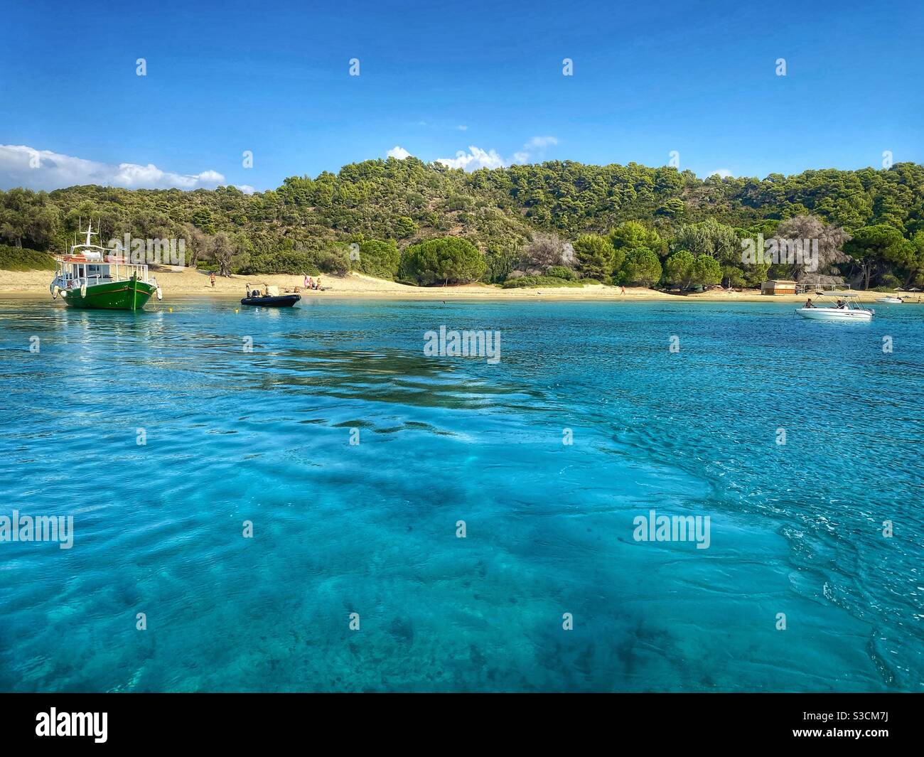 Turquoise waters at the uninhabited Tsougrias island near Skiathos, Greece. - Smartphone Captured Stock Image