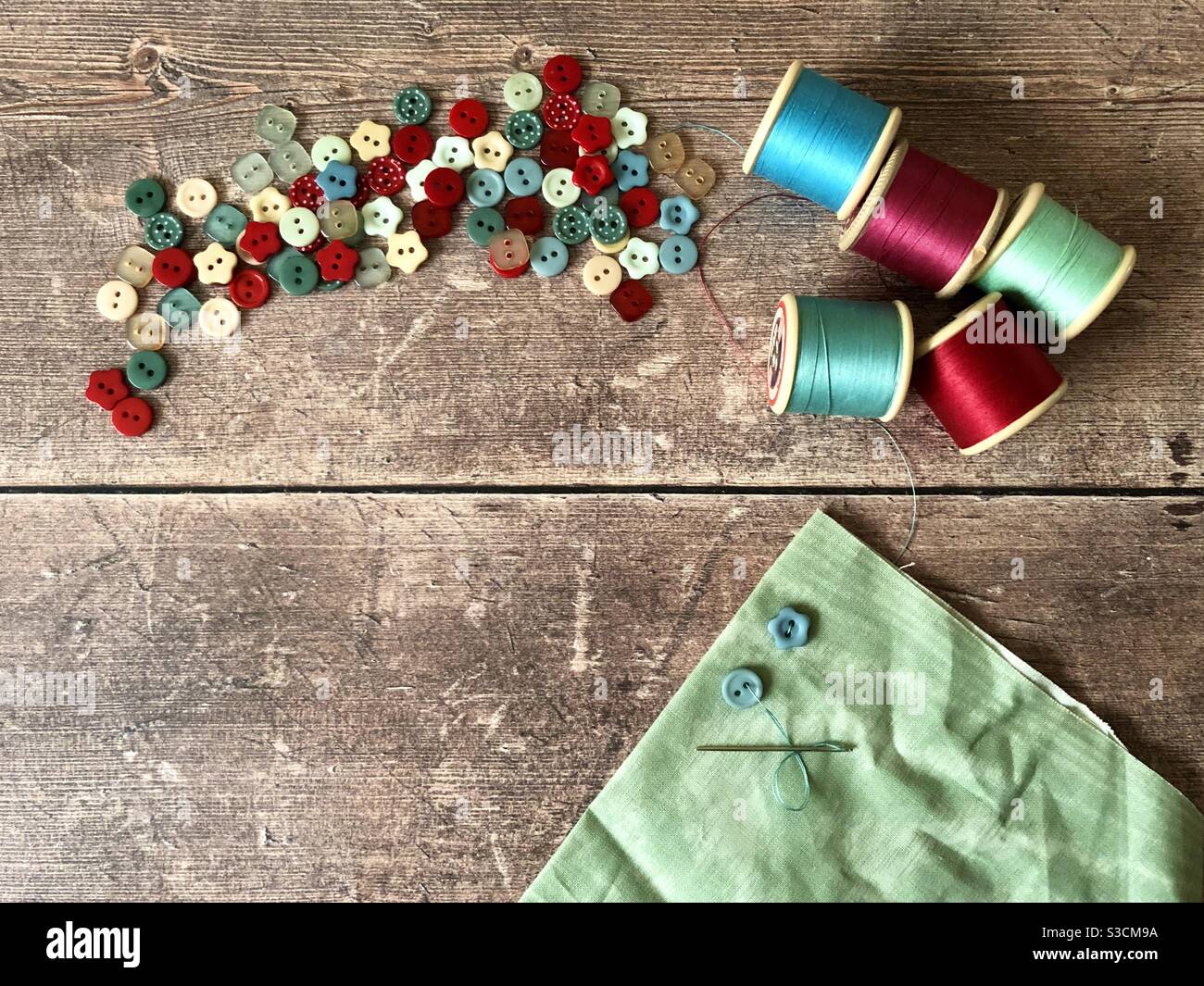 Sewing buttons onto fabric Stock Photo Alamy