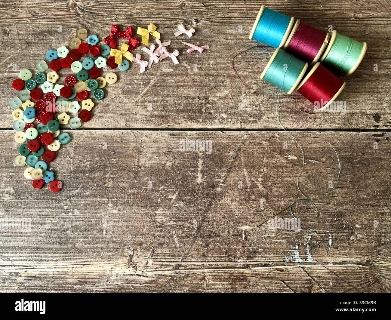 Sewing accessories on a wooden background with copy space - Smartphone Captured Stock Image