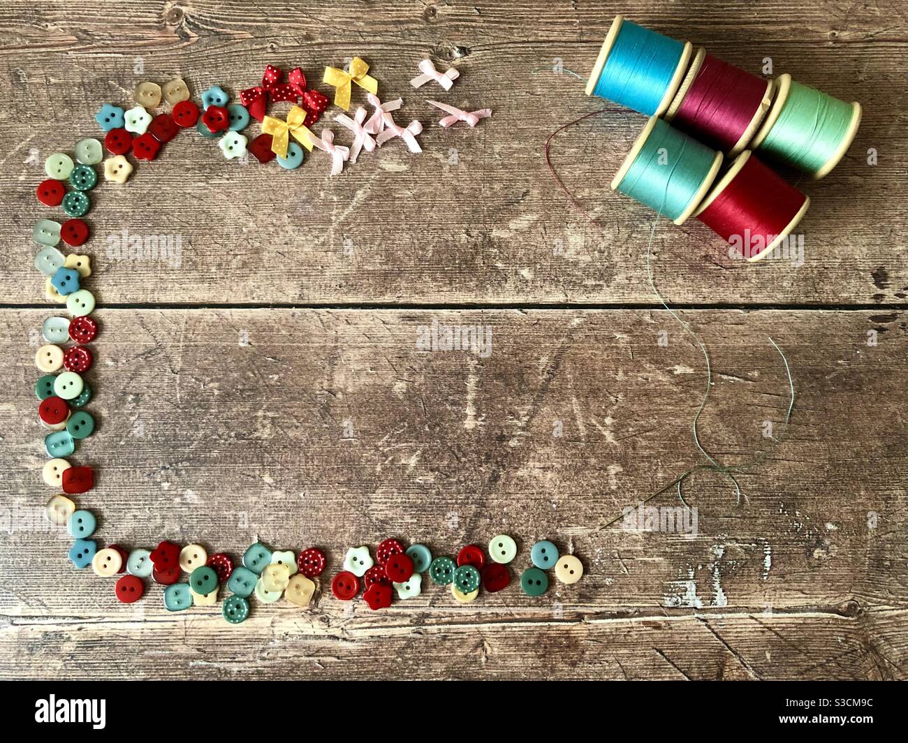 Sewing accessories on a wooden background with copy space - Smartphone Captured Stock Image