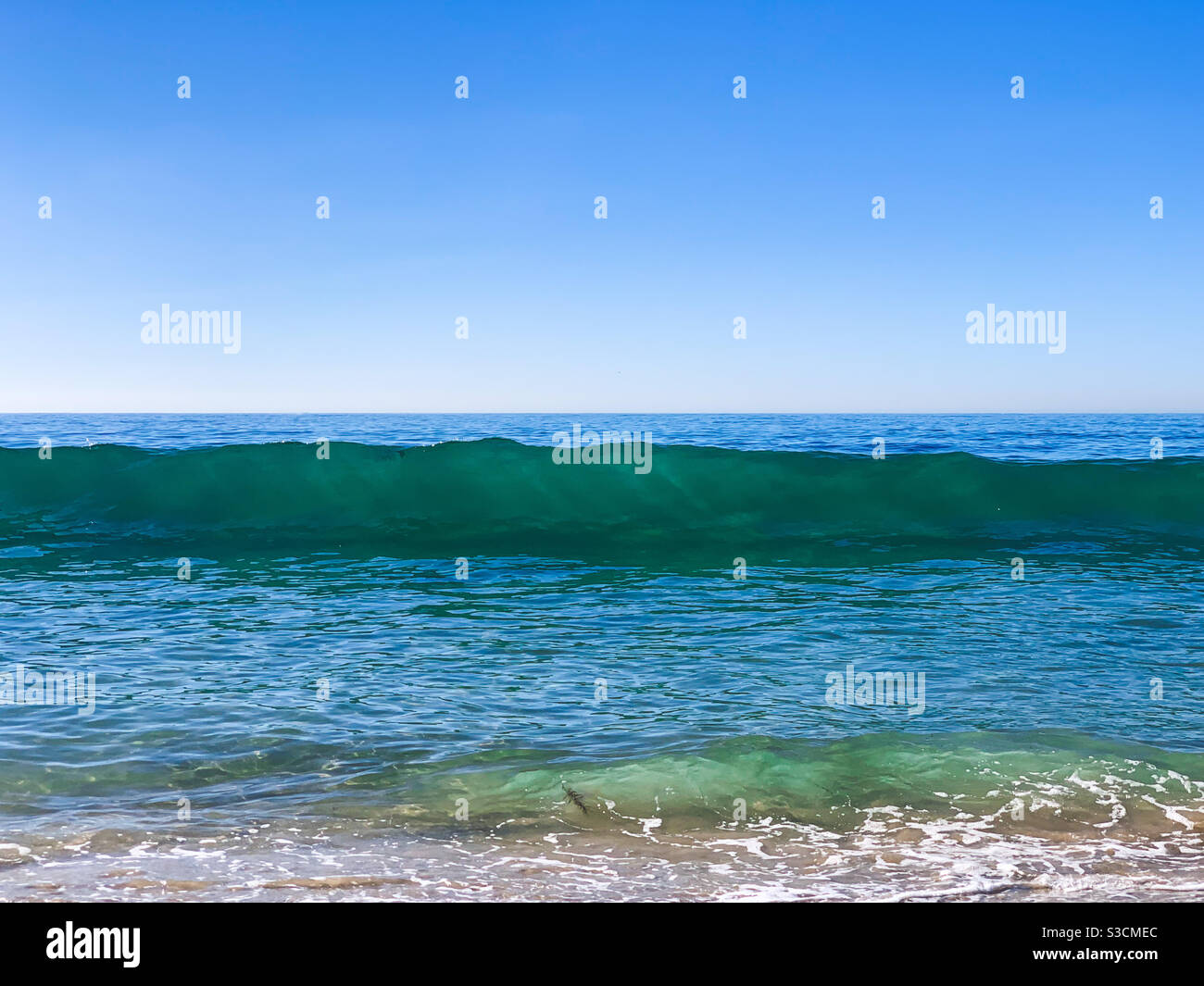 Ocean seascape with blue sky and turquoise wave. Stock Photo