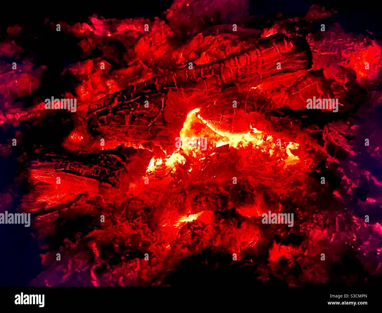Glowing logs and embers of a campfire Stock Photo