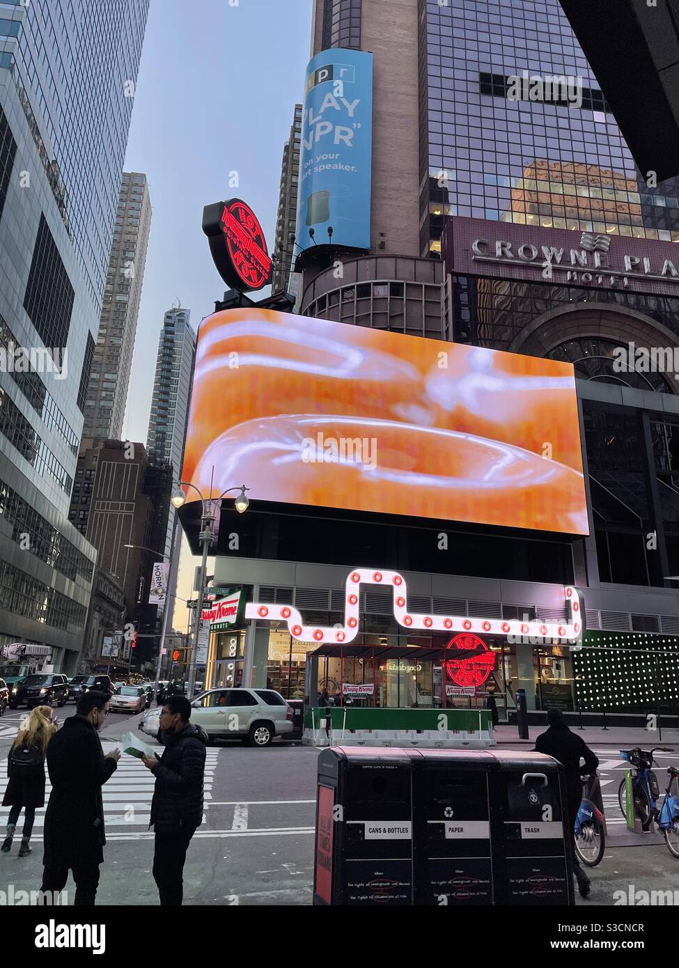 Does looking at this giant neon sign over Krispy Kreme store in Times Square, New York make you crave donuts? - Smartphone Captured Stock Image