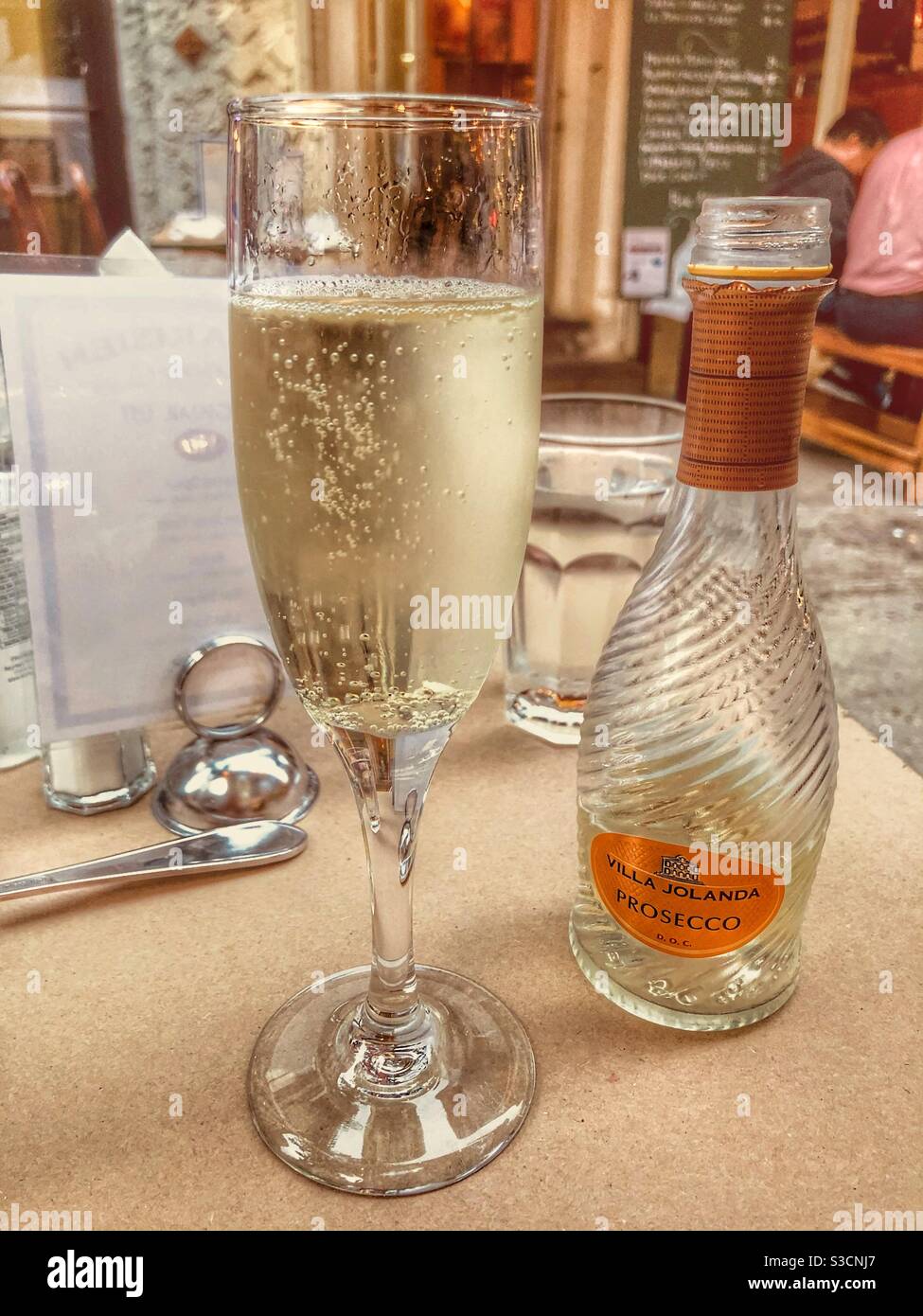 I stopped for a crisp bubbly refreshing glass of Prosecco at the French bistro in Murray Hill, New York City, USA and enjoyed people watching from their sidewalk dining area - Smartphone Captured Stock Image