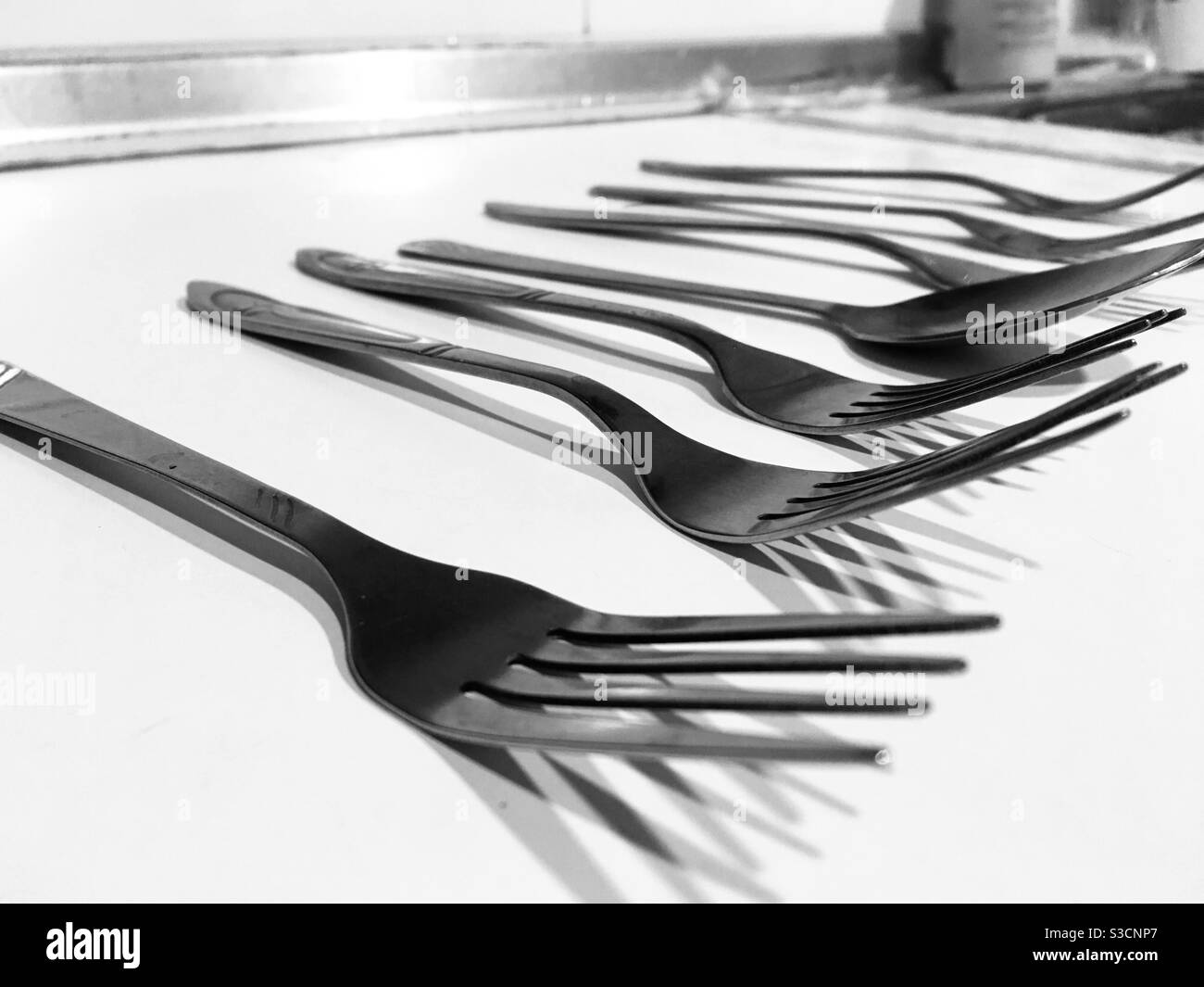 Black and white fork spoon at the middle Stock Photo