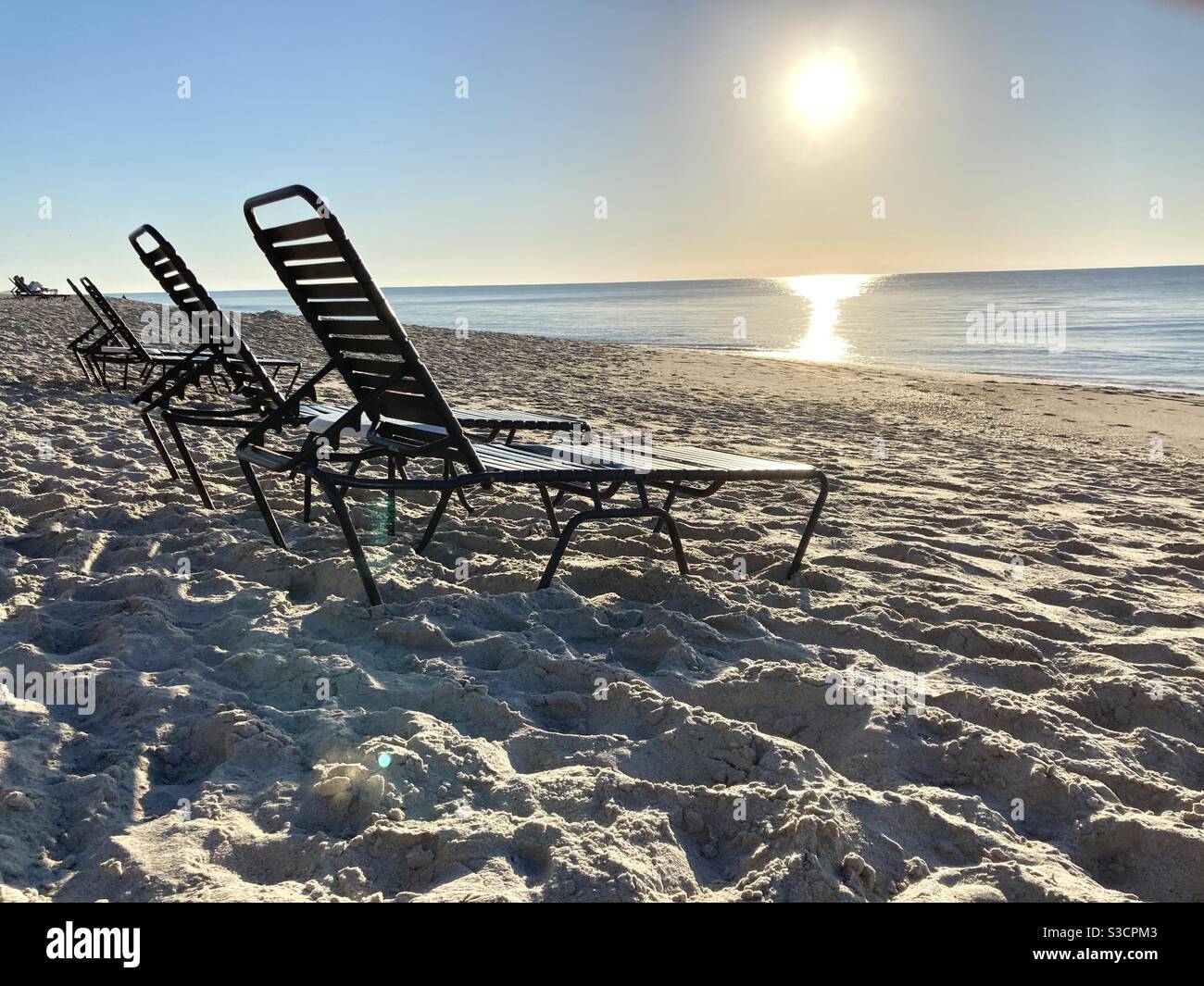 Lonely beach chairs with a rising sun in the background,Vero beach Florida Stock Photo Alamy