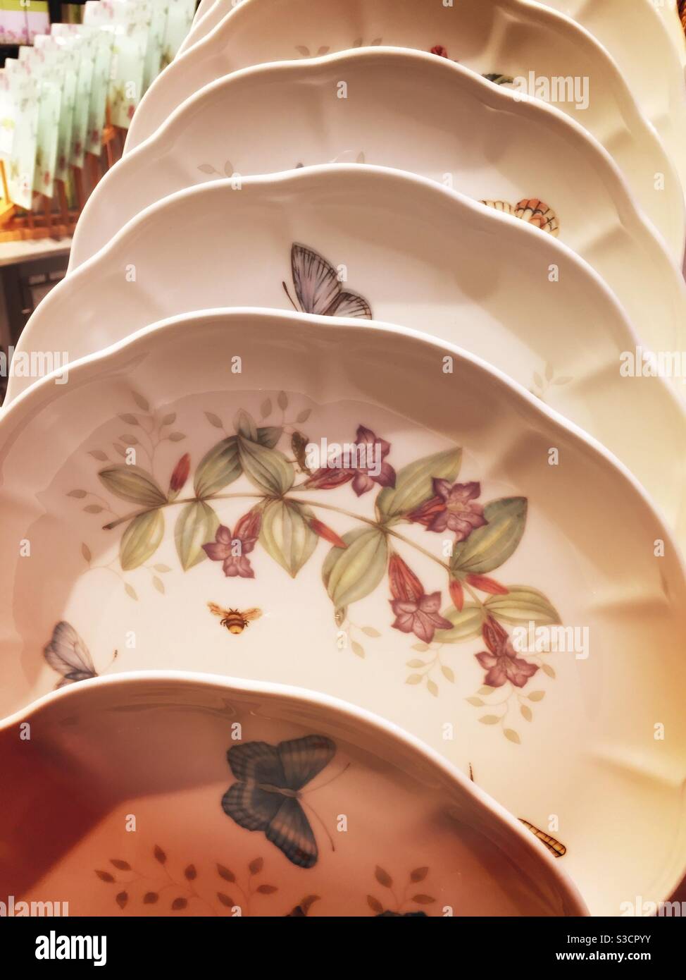 Display of patterned colorful plates for sale in a retail store, USA - Smartphone Captured Stock Image