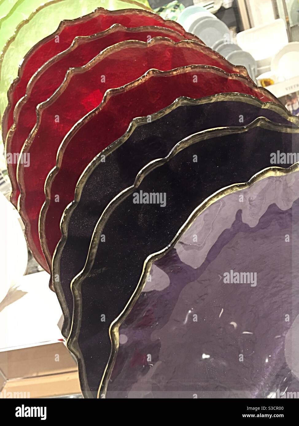 Multi colored glass plates in a retail display for sale in a department store, USA - Smartphone Captured Stock Image