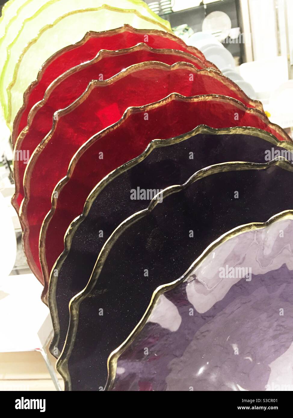 Display of multi colored glass plates for sale in a department store, USA - Smartphone Captured Stock Image
