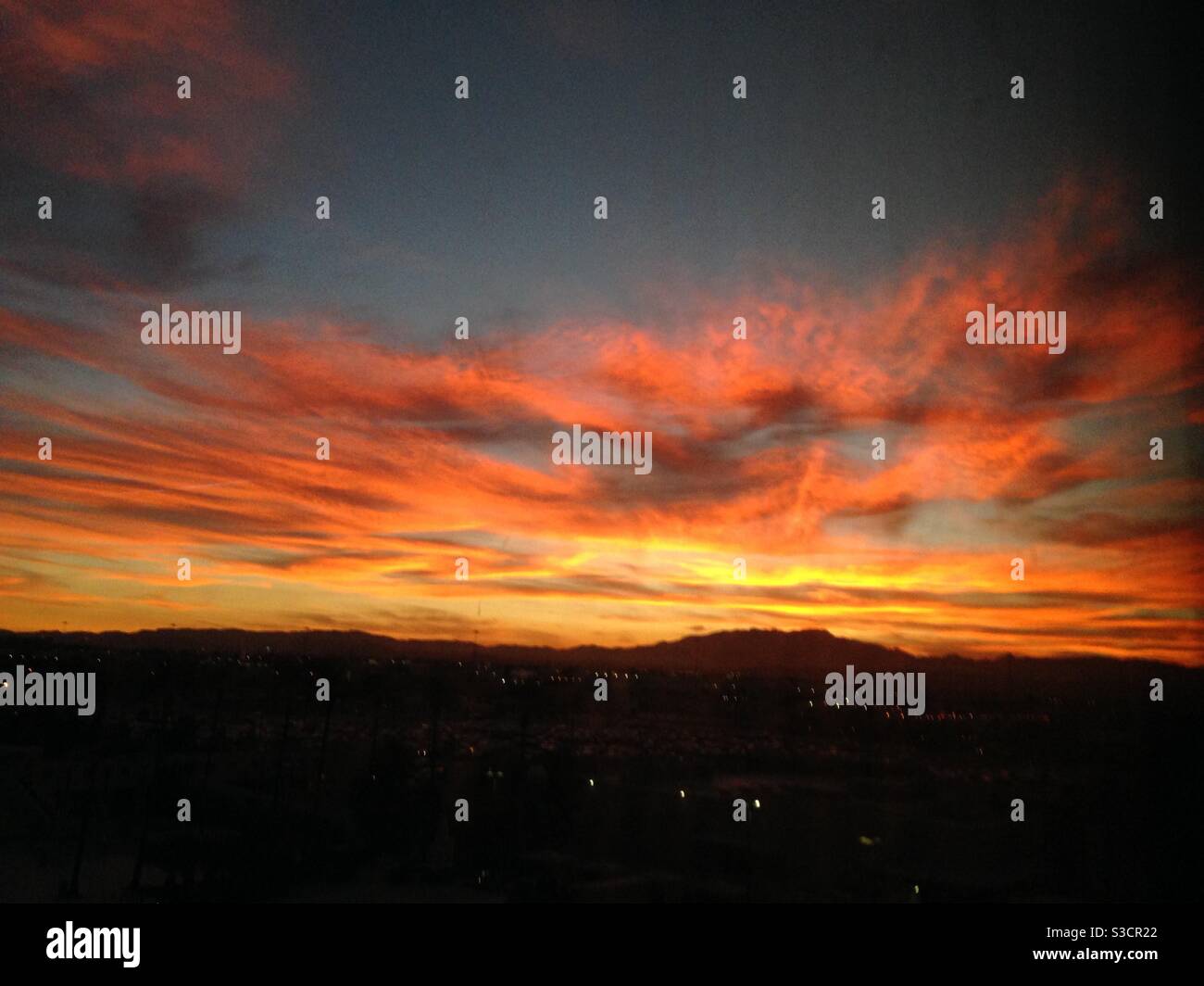 The brilliantly fierce colors of a desert sunset over the Las Vegas strip in Nevada, USA - Smartphone Captured Stock Image