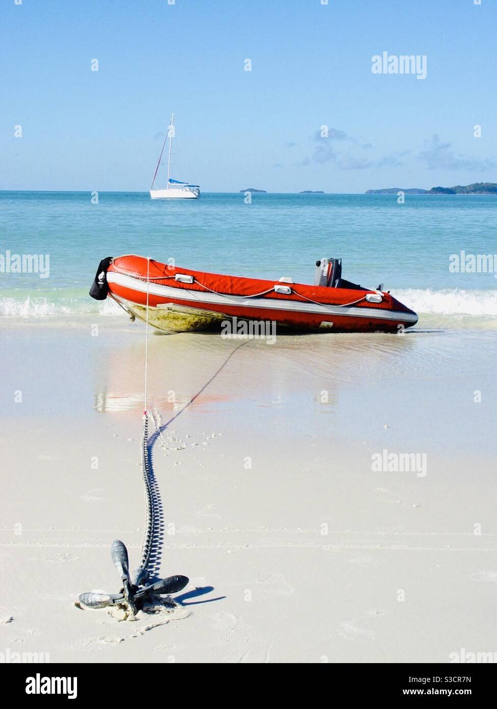Dingy tender anchored on the beach with yacht in the background Whitehaven Beach Whitsundays Queensland Australia - Smartphone Captured Stock Image