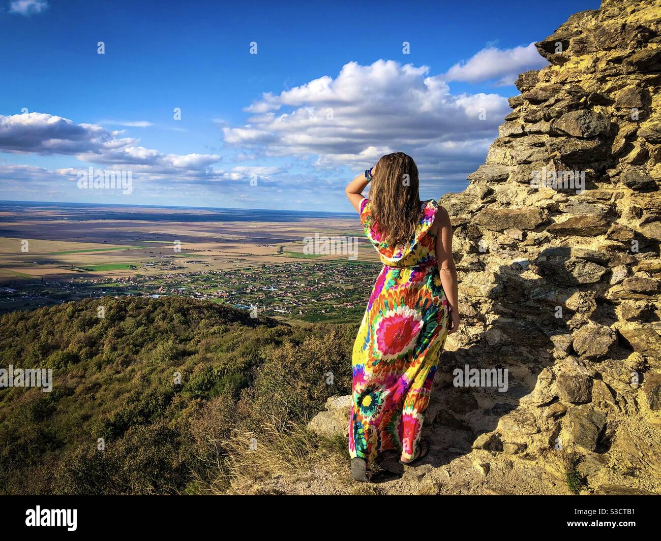 Woman in long dress looking at the mountains - Smartphone Captured Stock Image