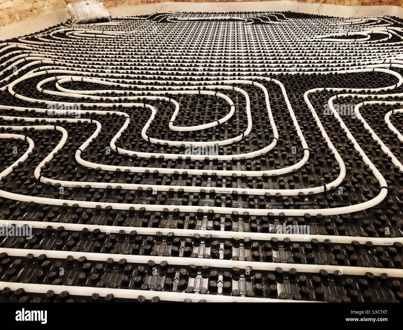 Underfloor heating tubes in a geometric pattern Stock Photo Alamy