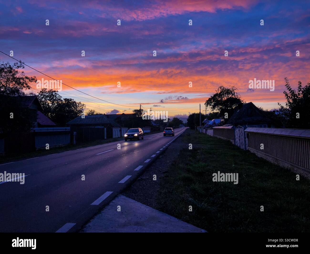Cars driving on a road at sunset - Smartphone Captured Stock Image