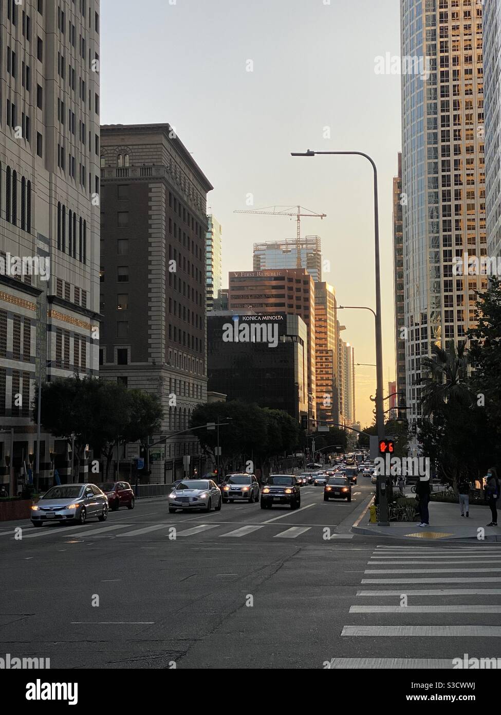 LOS ANGELES, CA, NOV 2020: looking southward at traffic on Figueroa Street in Downtown, backlit by setting sun - Smartphone Captured Stock Image