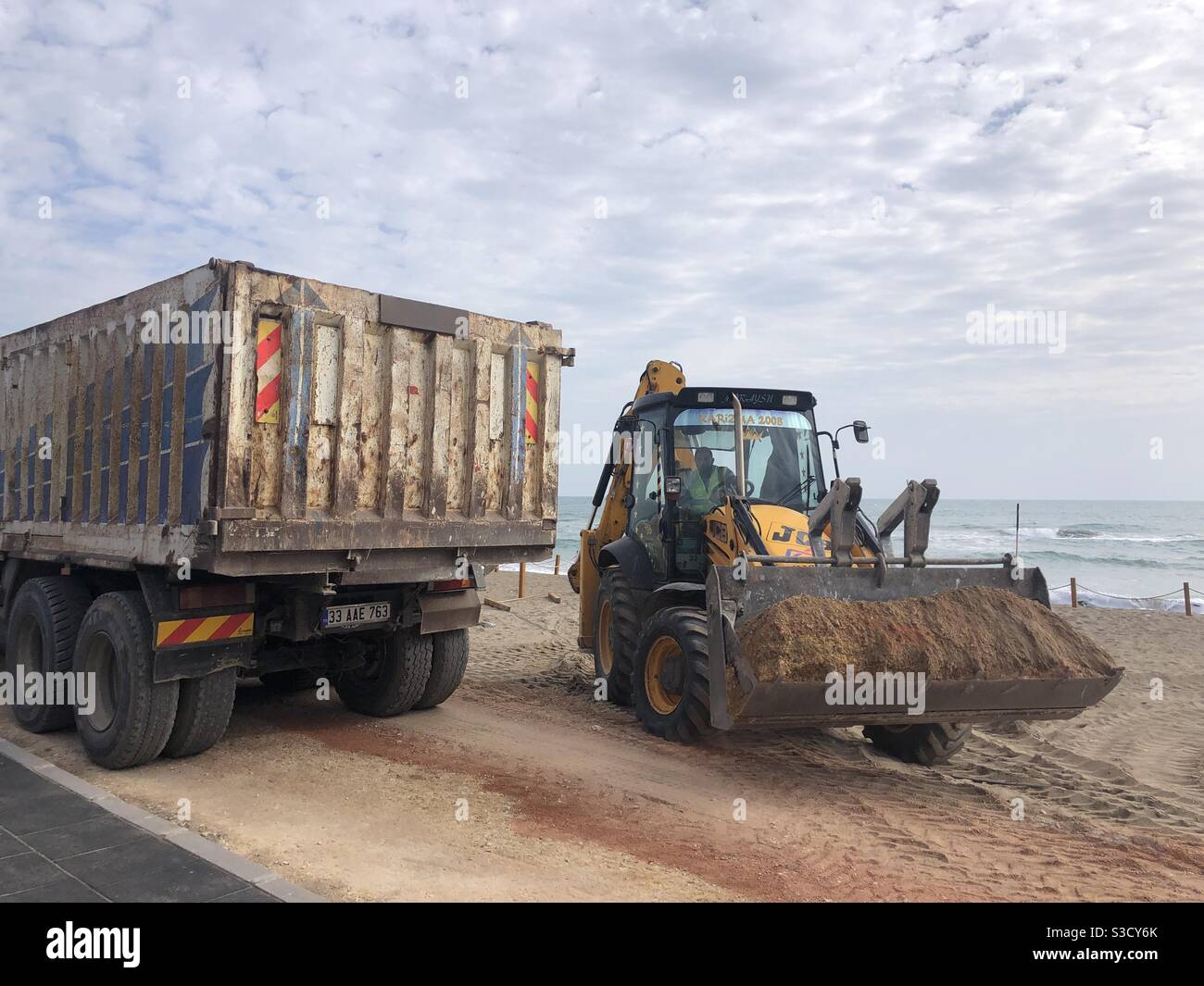 Excavator and a truck by the sea - Smartphone Captured Stock Image