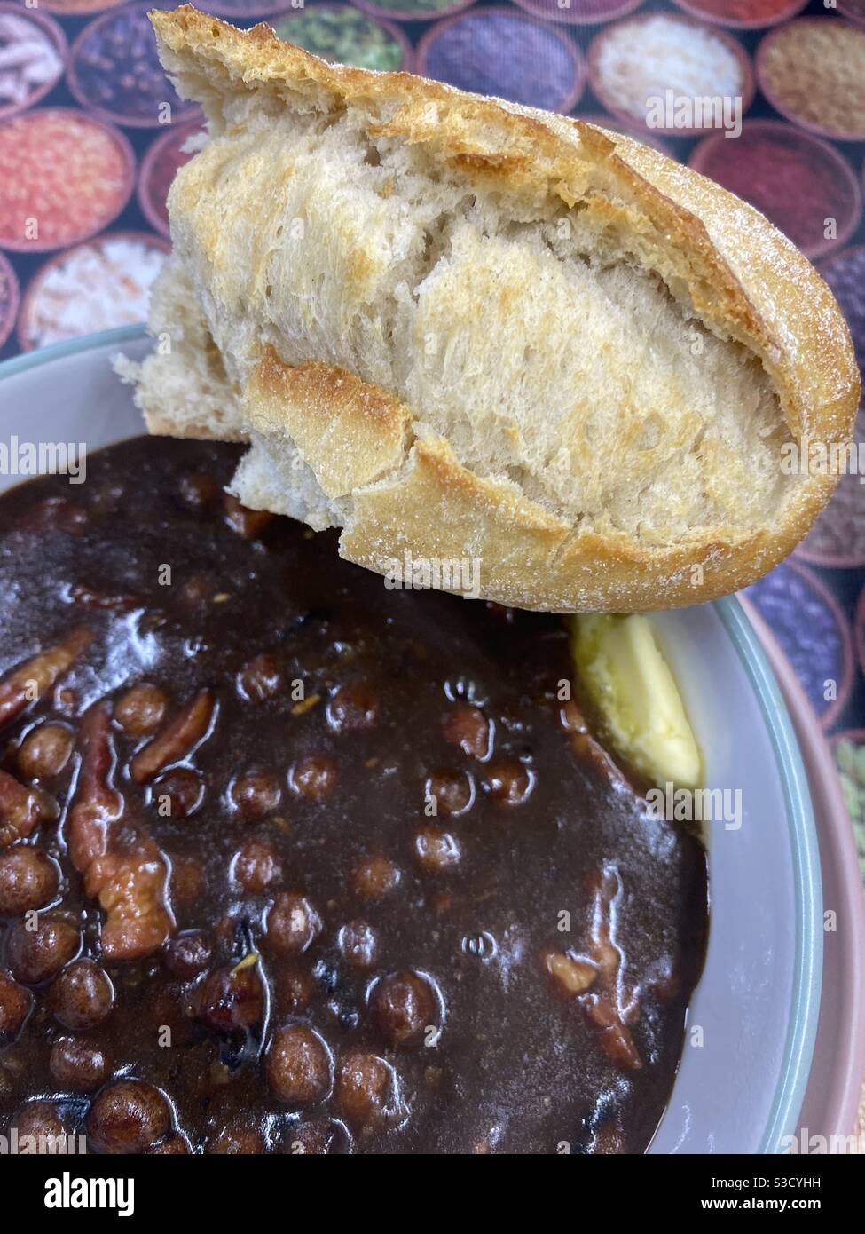 Rich Black Peas with Crusty Bread and Butter in a rich stock sauce - Smartphone Captured Stock Image