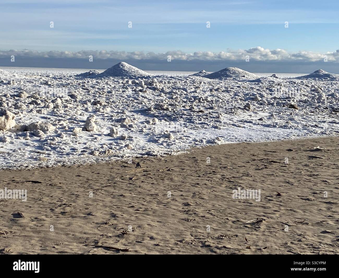 Frozen snow-covered Lake Michigan shoreline after a winter storm. Stock Photo