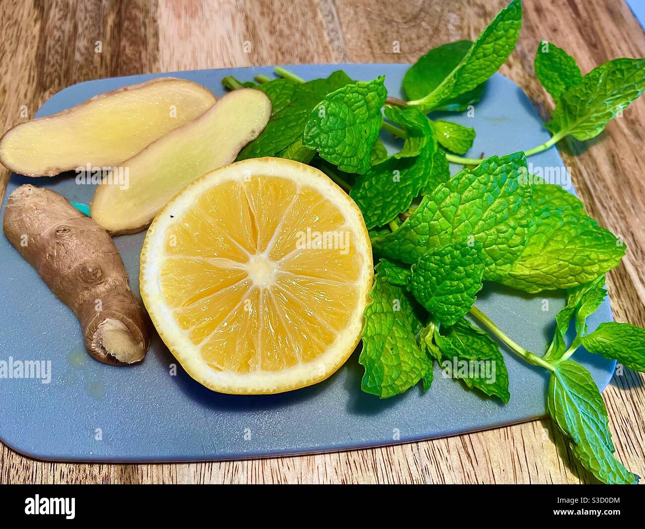For a refreshing healthy drink, have you tried fresh ginger, mint, and lemon in your water or tea? - Smartphone Captured Stock Image