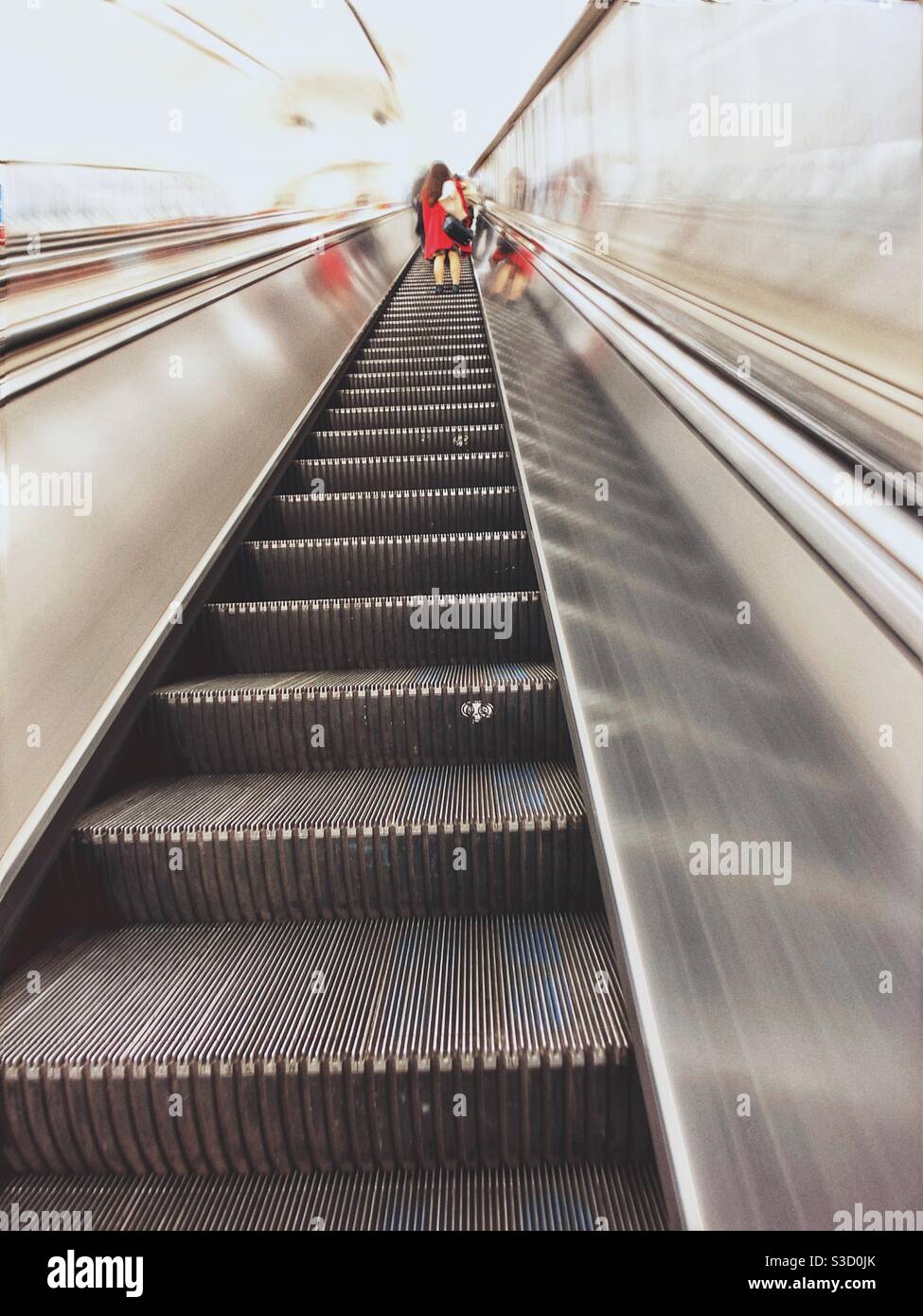 Woman on escalator - Smartphone Captured Stock Image