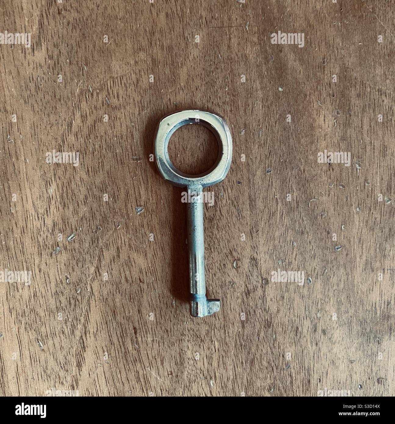 Metal key on wood Stock Photo