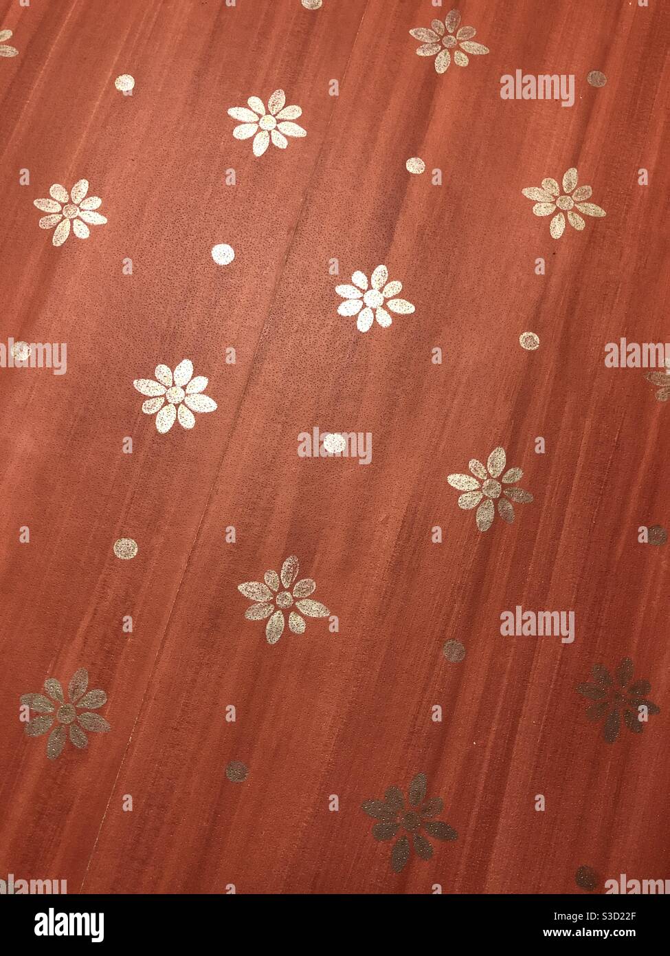 Pattern of silver flowers on a deep red background - Smartphone Captured Stock Image