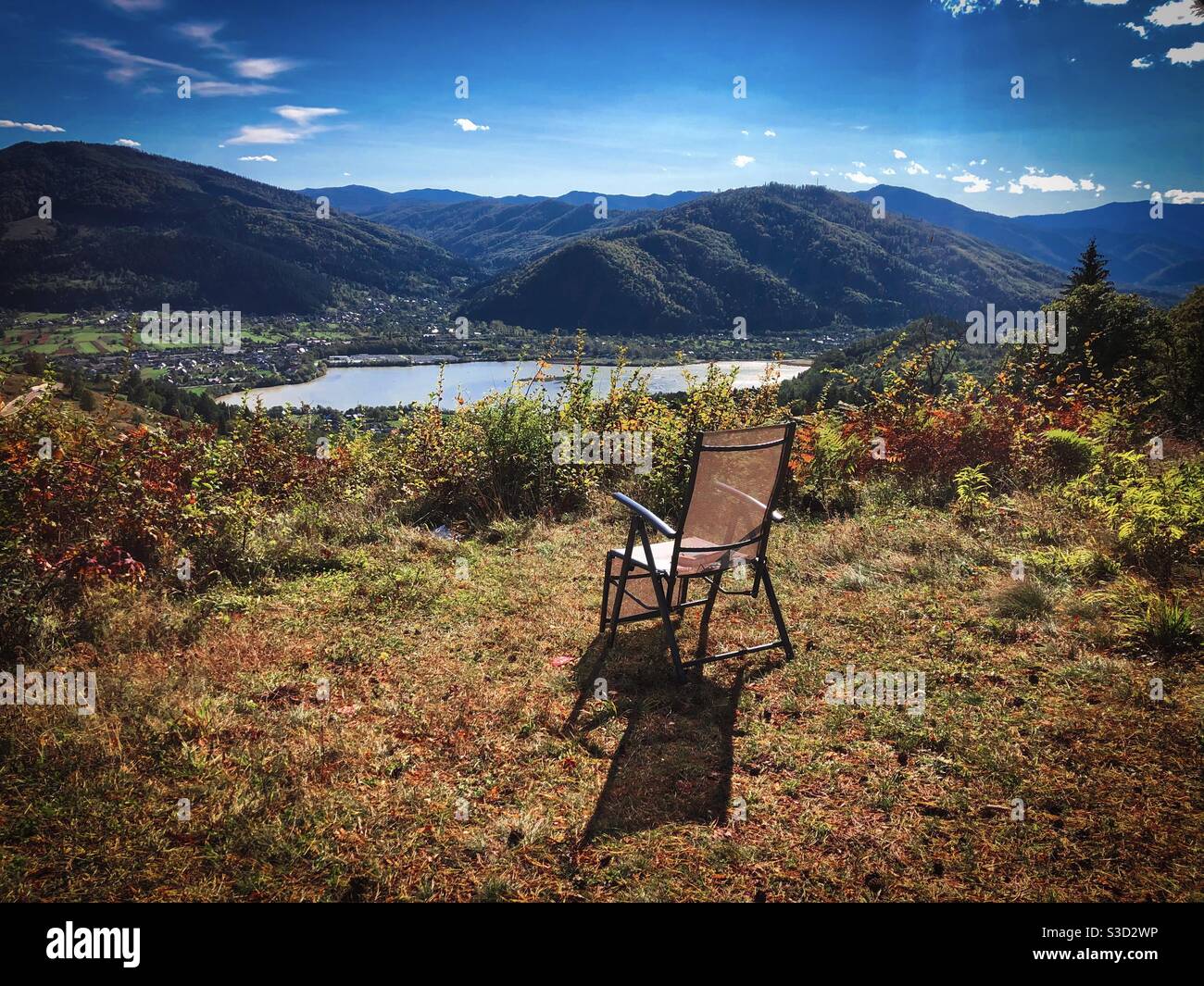 Empty chair with view of lake and mountains ahead - Smartphone Captured Stock Image