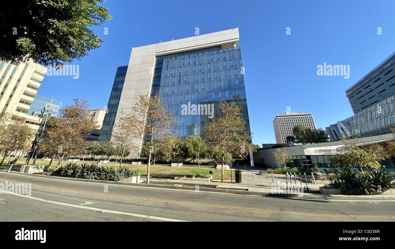 LOS ANGELES, CA, DEC 2020: wide angle view of small, inner-city park and nearby buildings at rear of Los Angeles Police Department Headquarters in Downtown, daytime - Smartphone Captured Stock Image