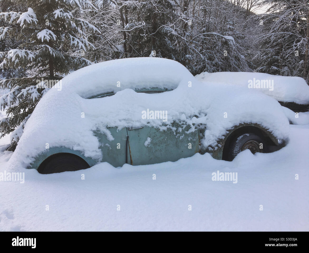 Old VW Beetle covered in snow. Stock Photo