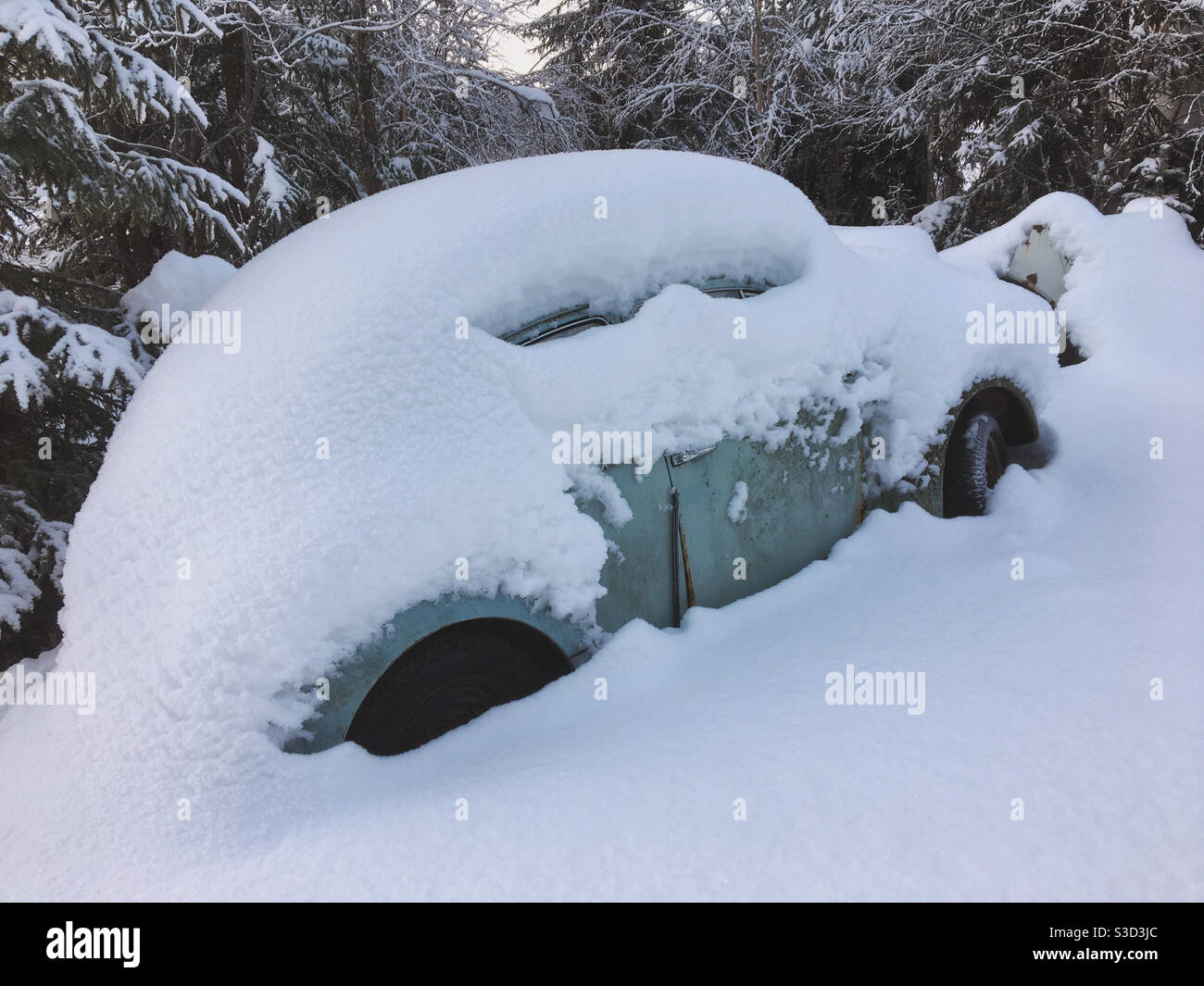 Old VW Beetle covered in snow. Stock Photo