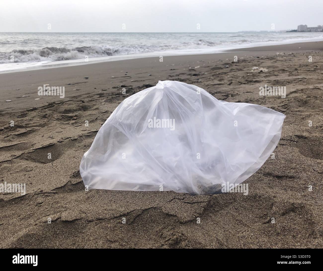 Plastic carrier bag left on the beach - Smartphone Captured Stock Image