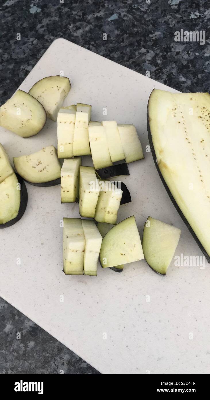 Chopped aubergine on a chopping board Stock Photo Alamy