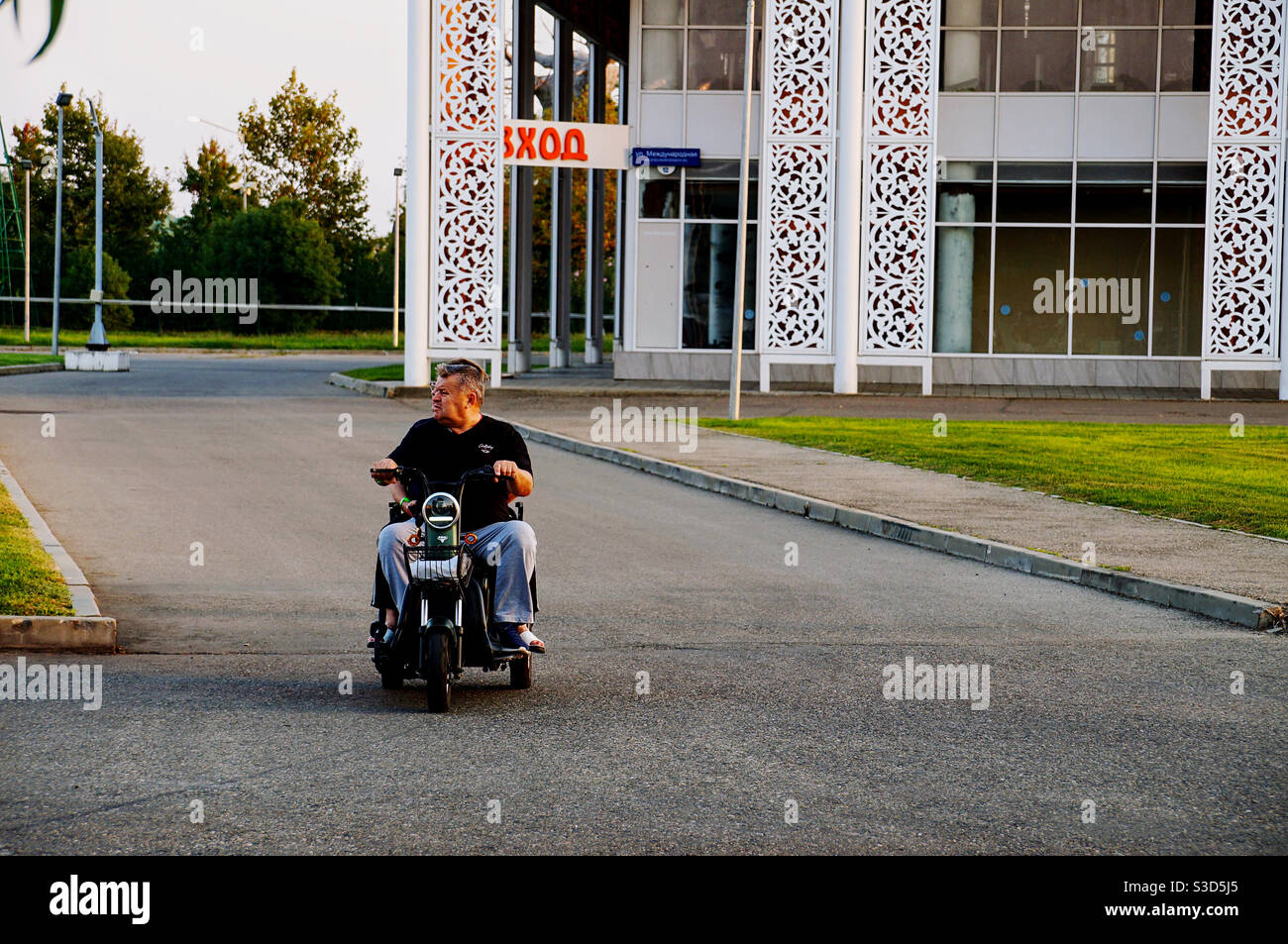 Adult man on a scooter watching the road - Smartphone Captured Stock Image