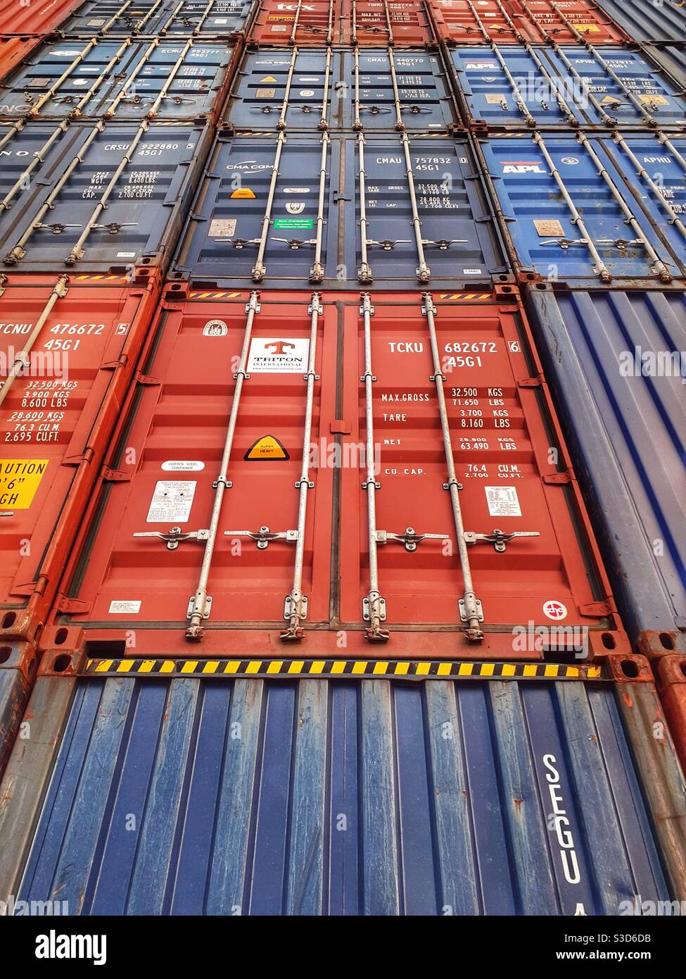 The ends of stacked shipping containers or cargo containers in a full frame background image - Smartphone Captured Stock Image