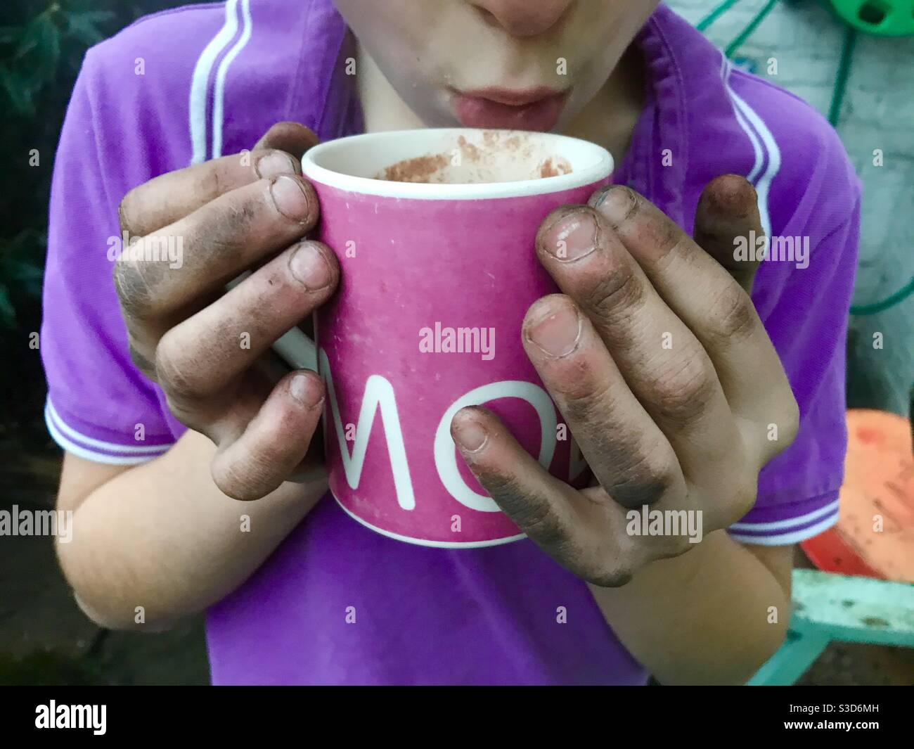 Boy drinking hot chocolate Stock Photo