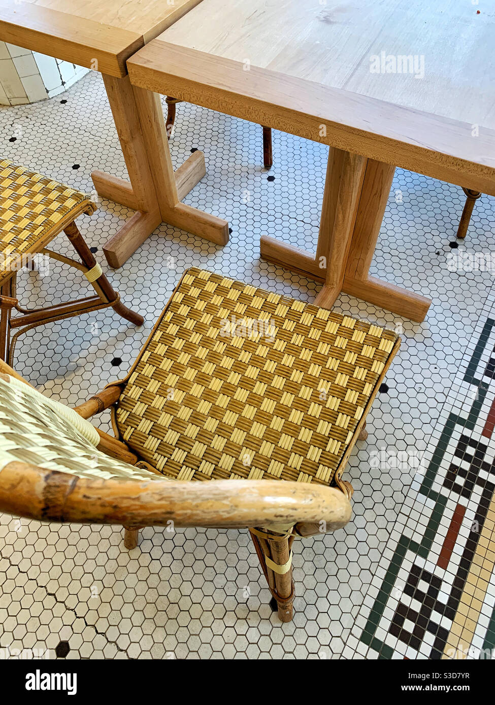 Empty table at dine-in restaurant with classic bistro chairs and tile floor - Smartphone Captured Stock Image