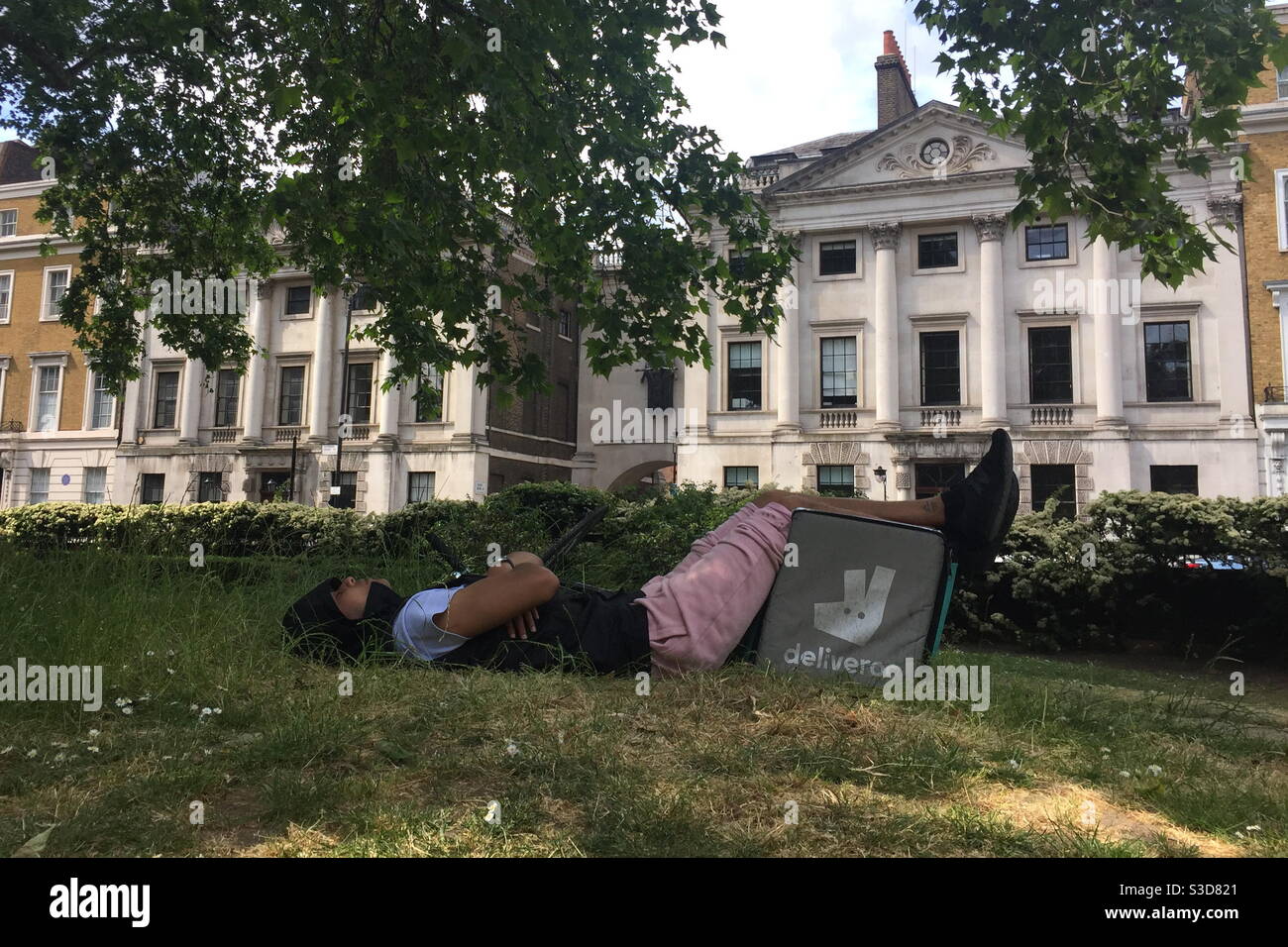 Tired Deliveroo worker - Smartphone Captured Stock Image