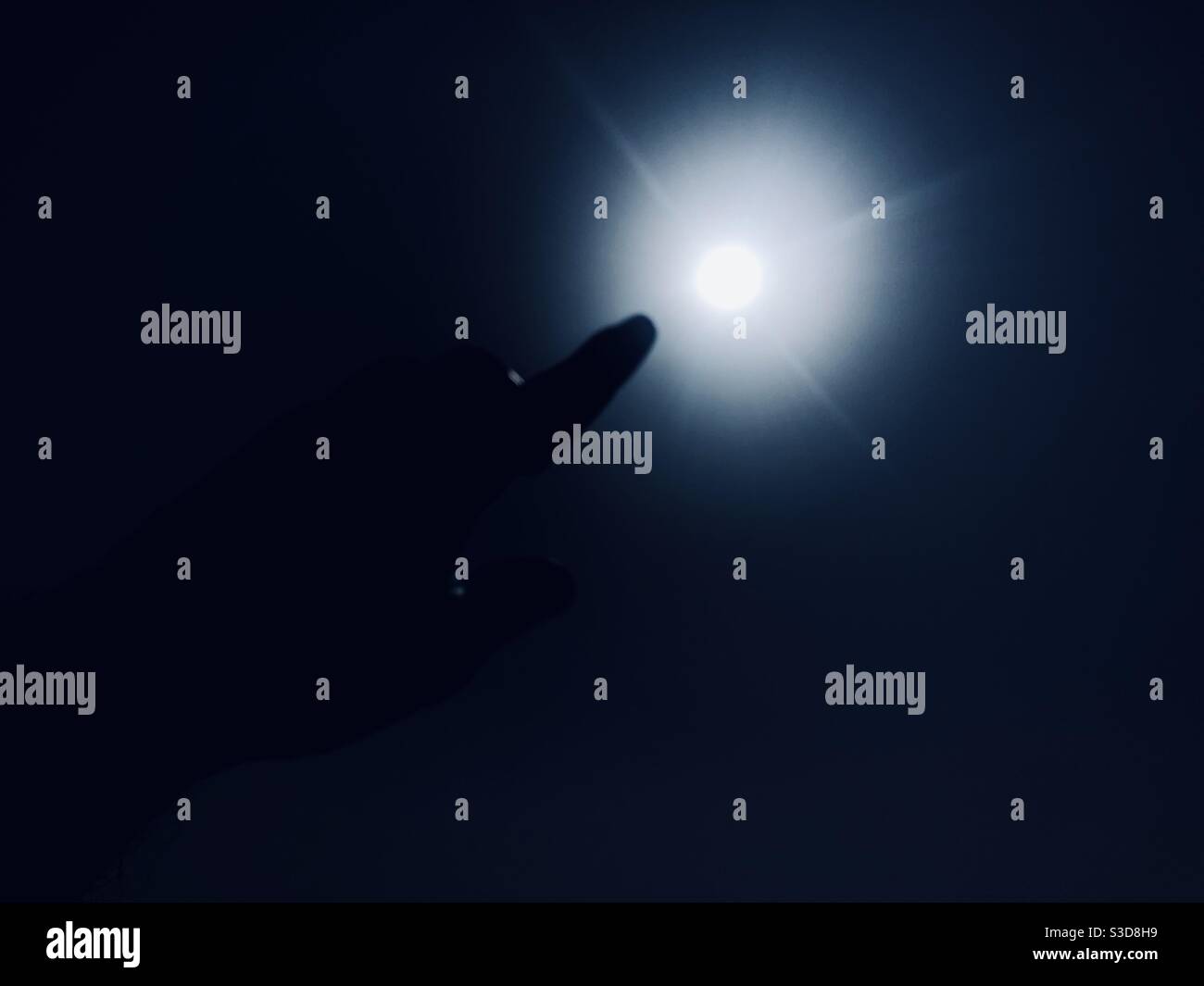 Finger pointing at the sun - Smartphone Captured Stock Image