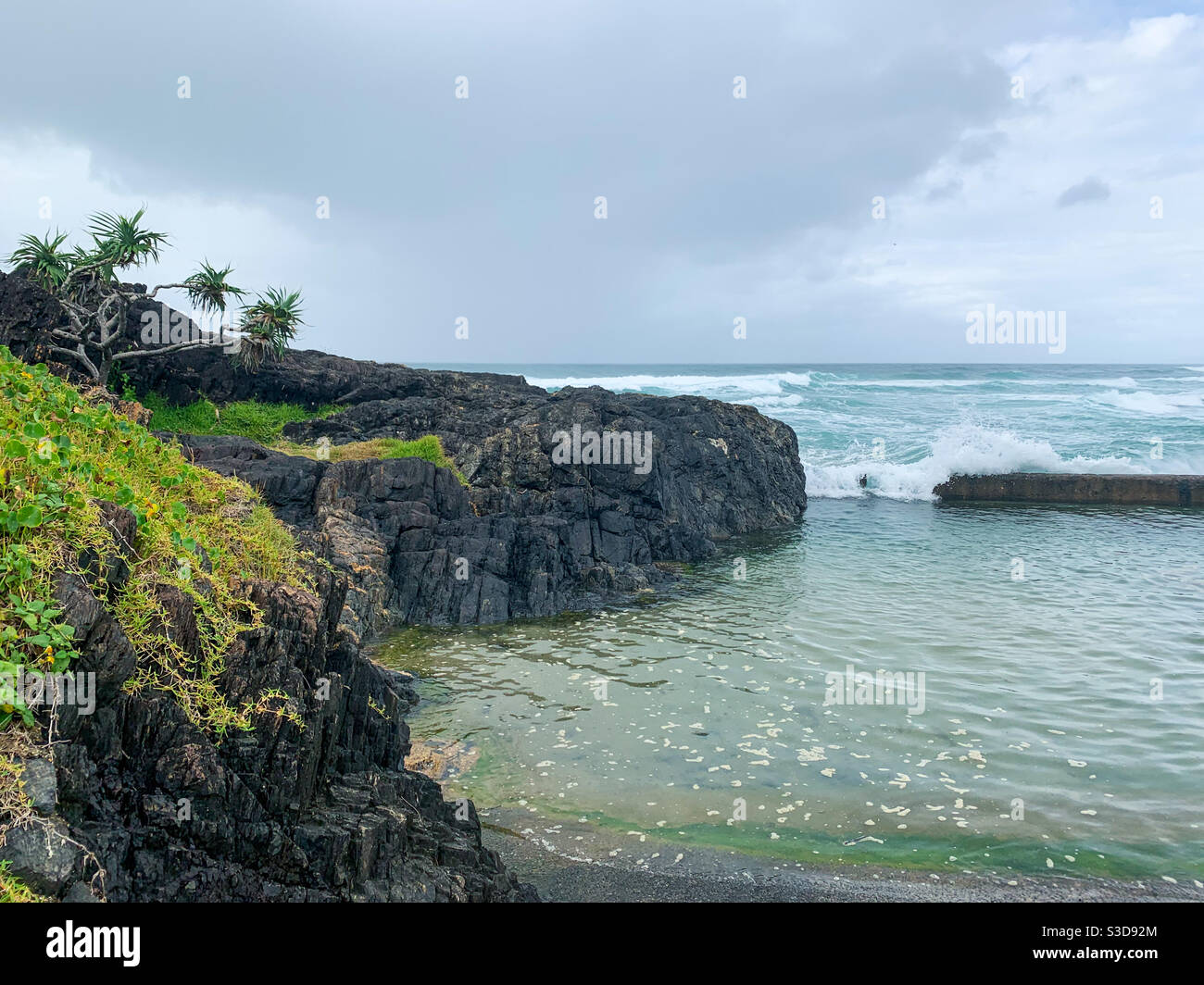 Picturesque Australian sea scape, looking out over the Wave Pool to the Pacific Ocean and horizon beyond - Smartphone Captured Stock Image