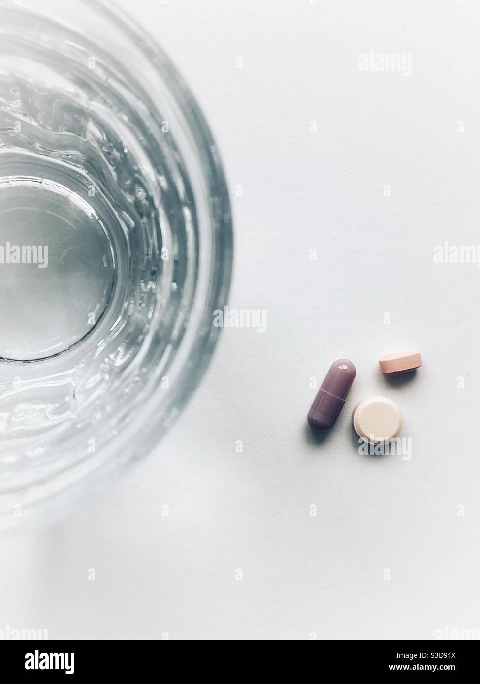 3 pills and a glass of water Stock Photo