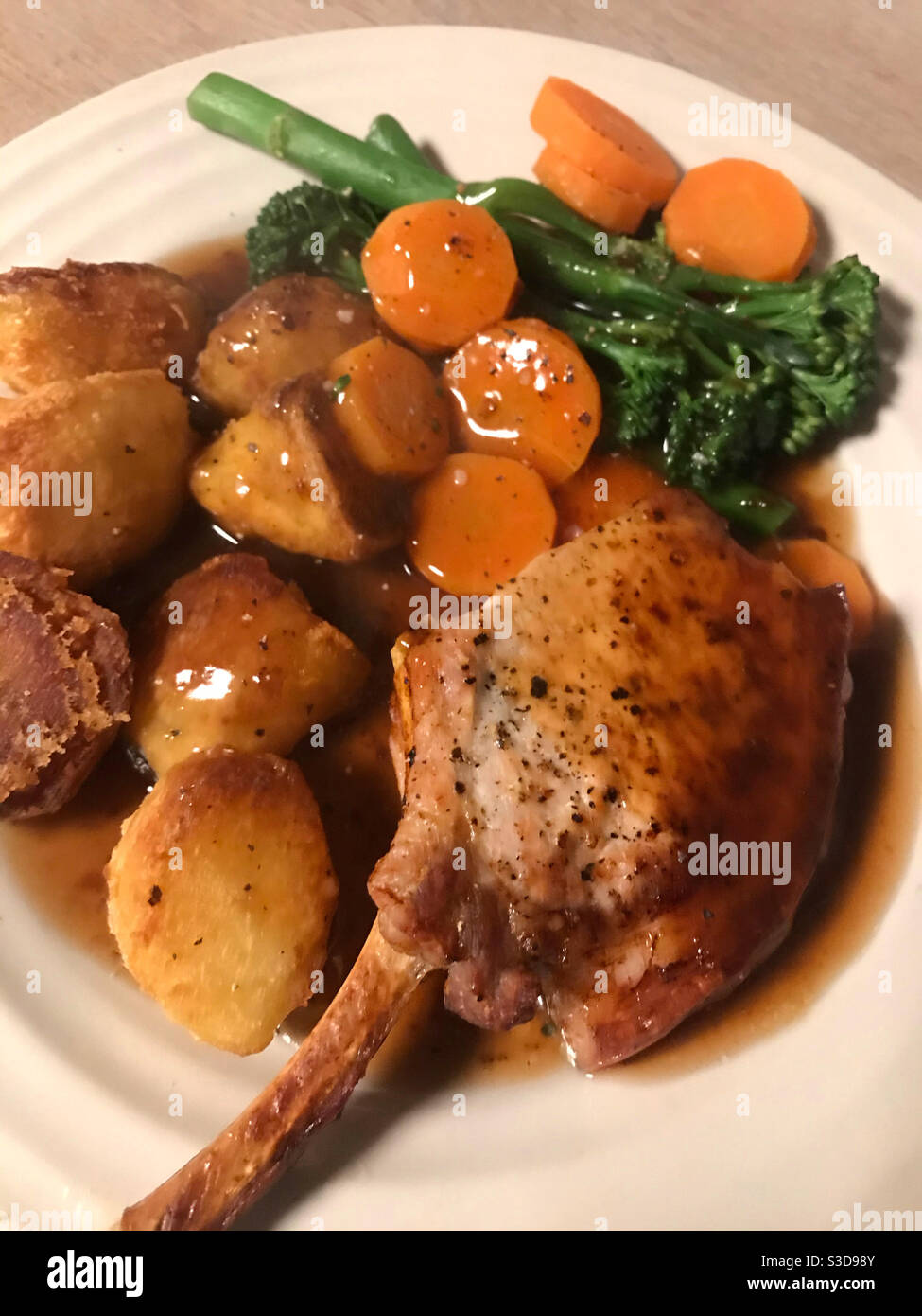 A traditional Sunday lunch with a pork chop - Smartphone Captured Stock Image